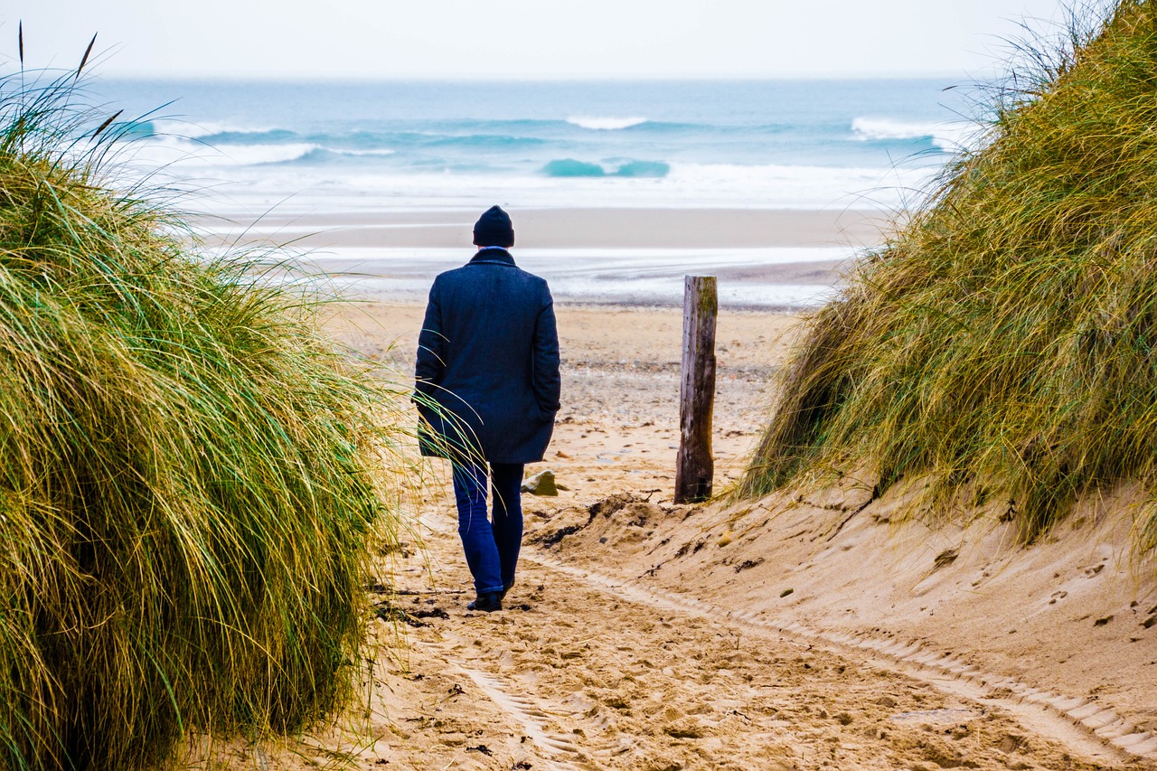 man at sea dune water free photo