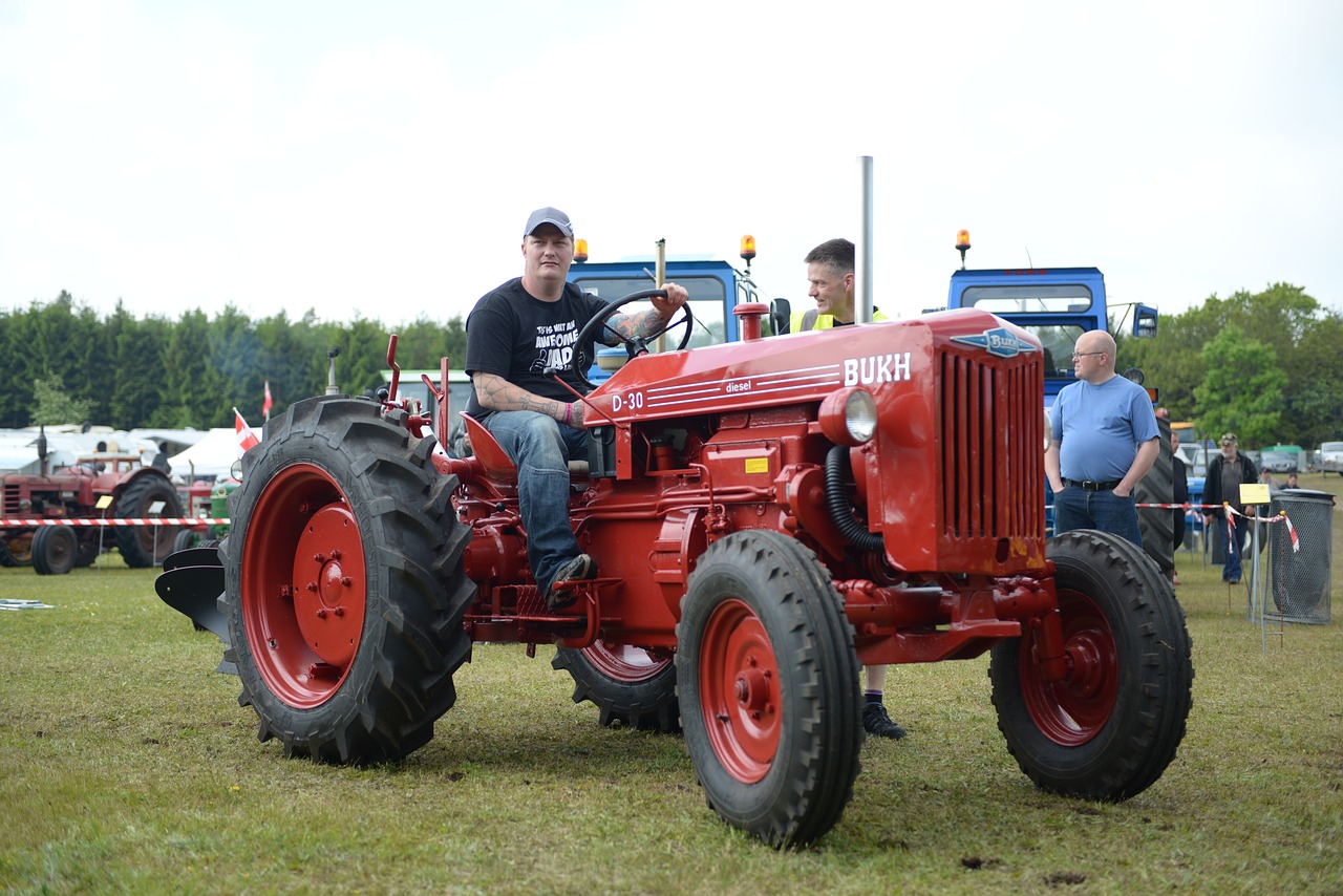 man on tractor red tractor old tractor free photo