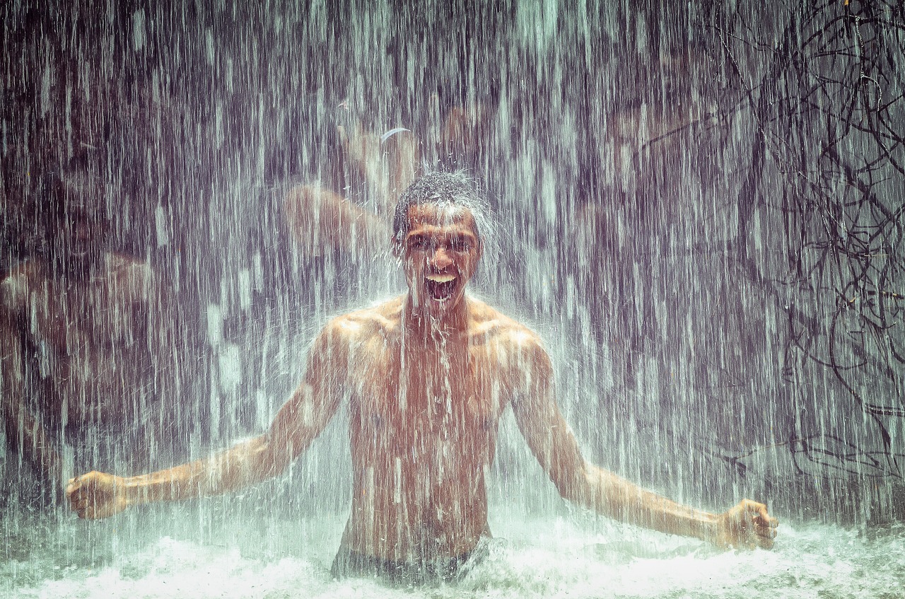 man under waterfall power waterfall free photo