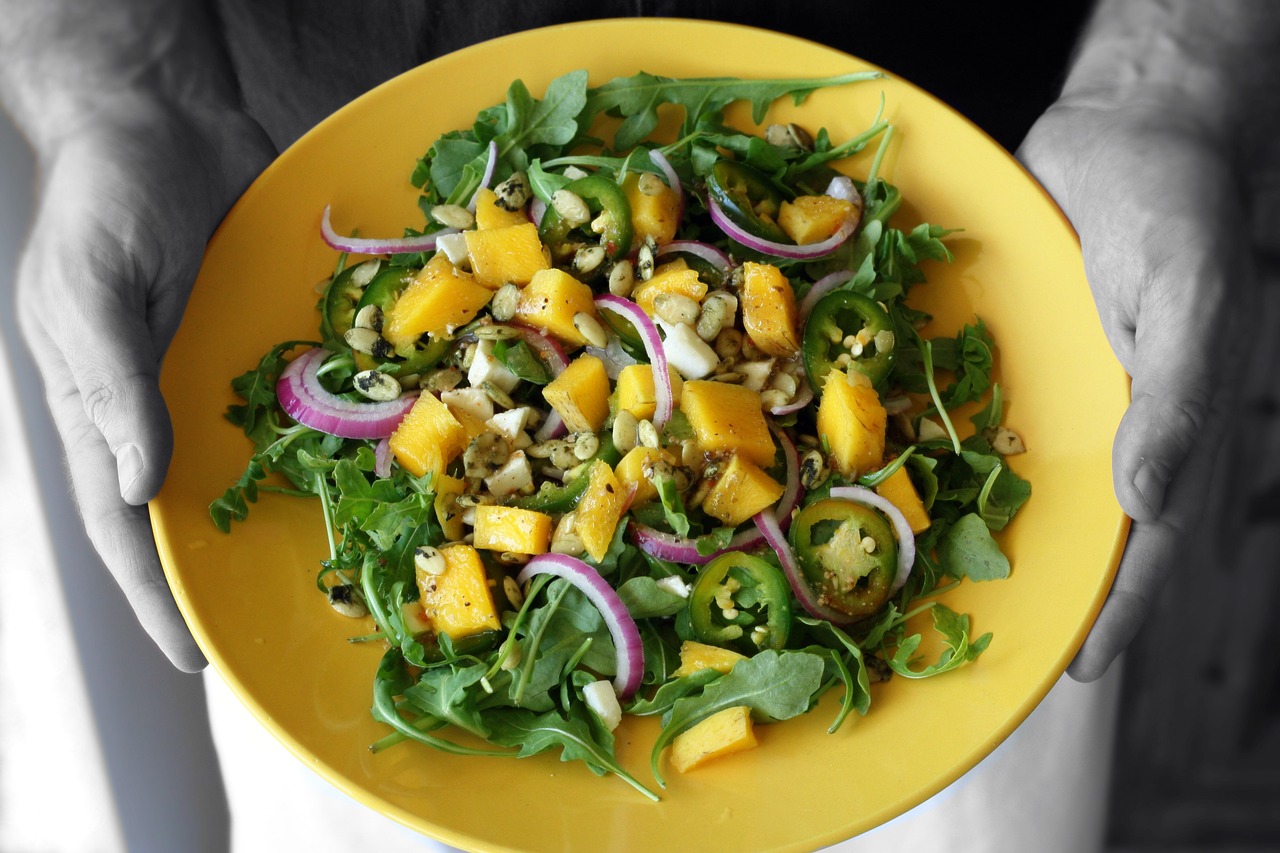 mango salad hands holding arugula free photo