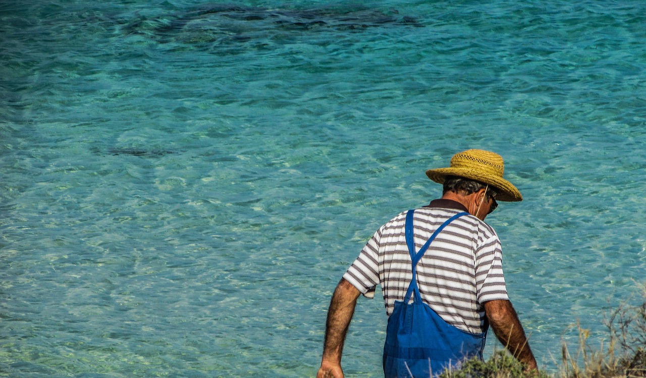 mature man walking sea free photo