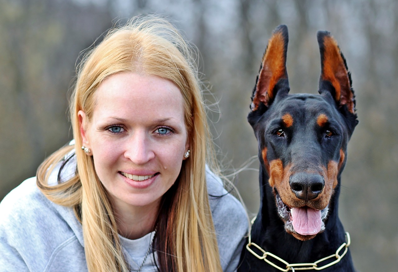 blonde woman woman and dog doberman free photo