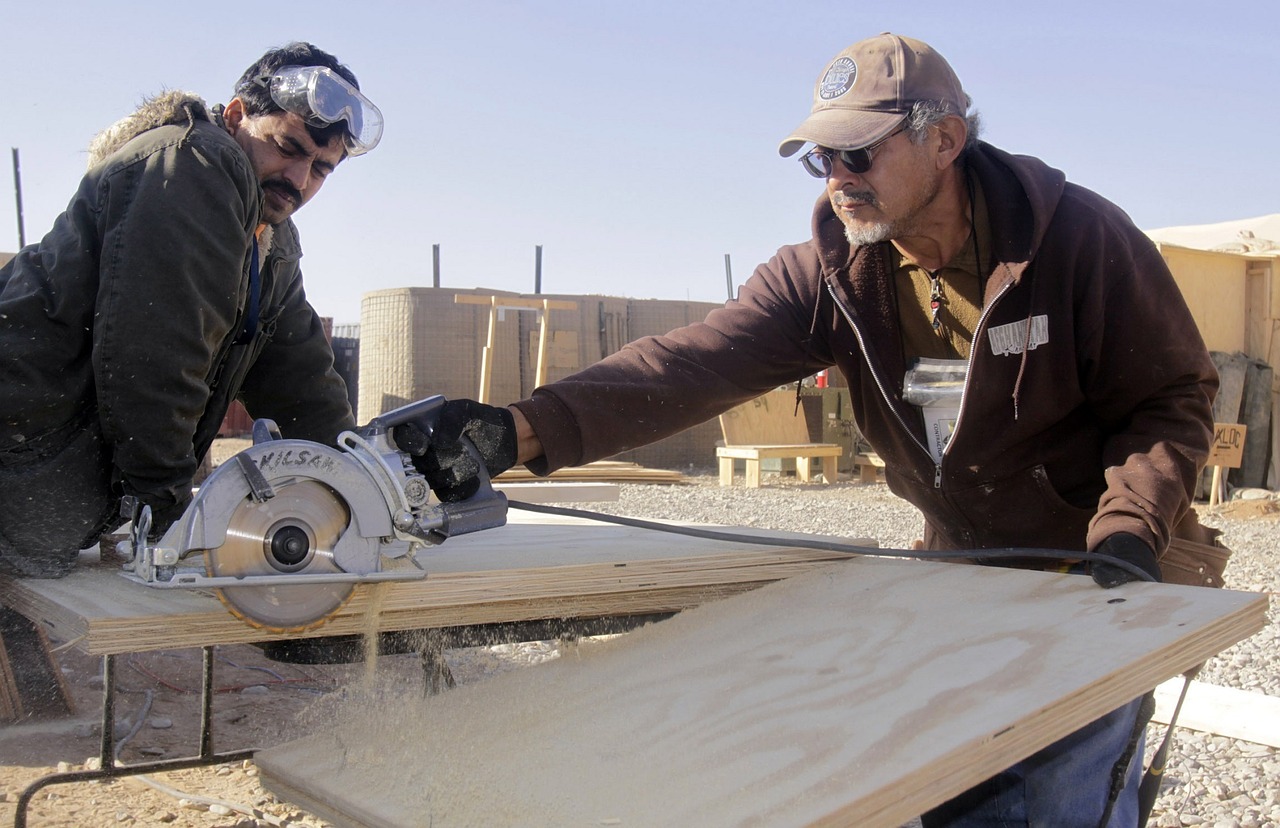 men working construction sawing free photo