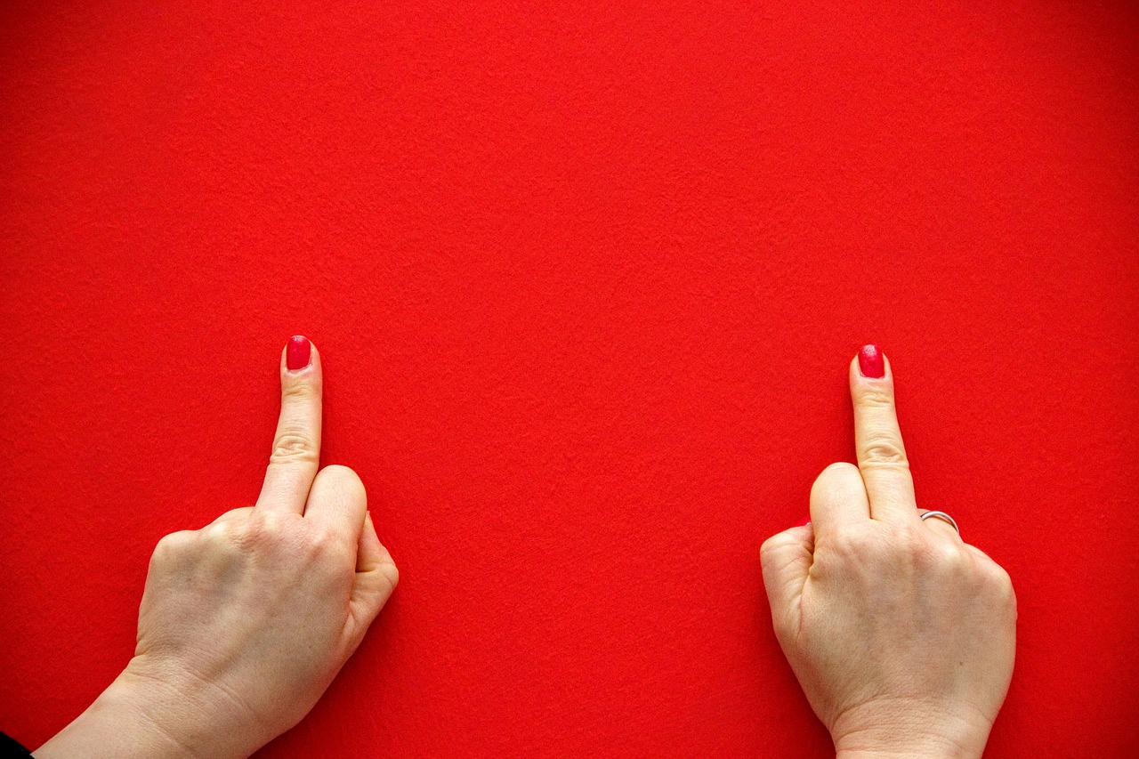 middle finger red background free photo