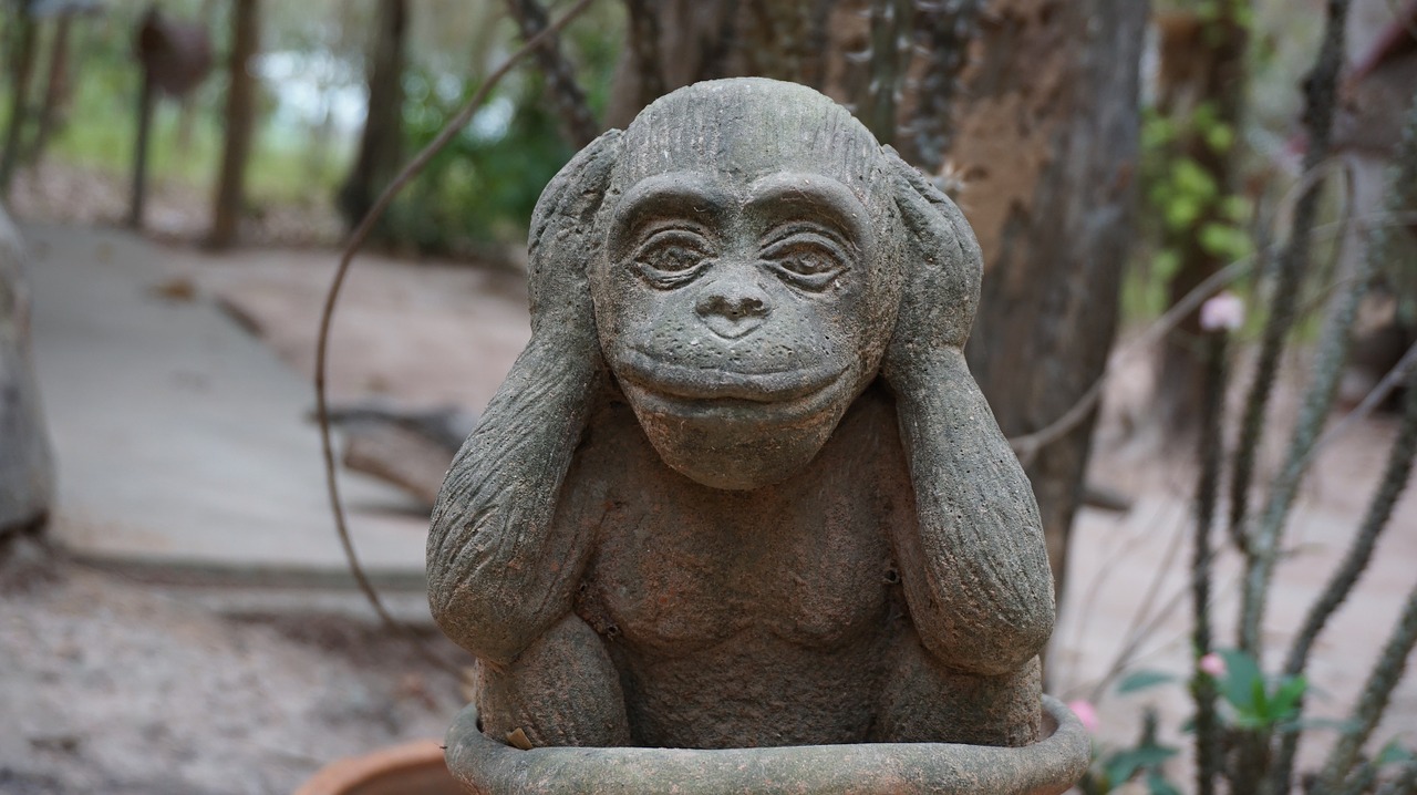 monkey statue closed-ear headphones free photo
