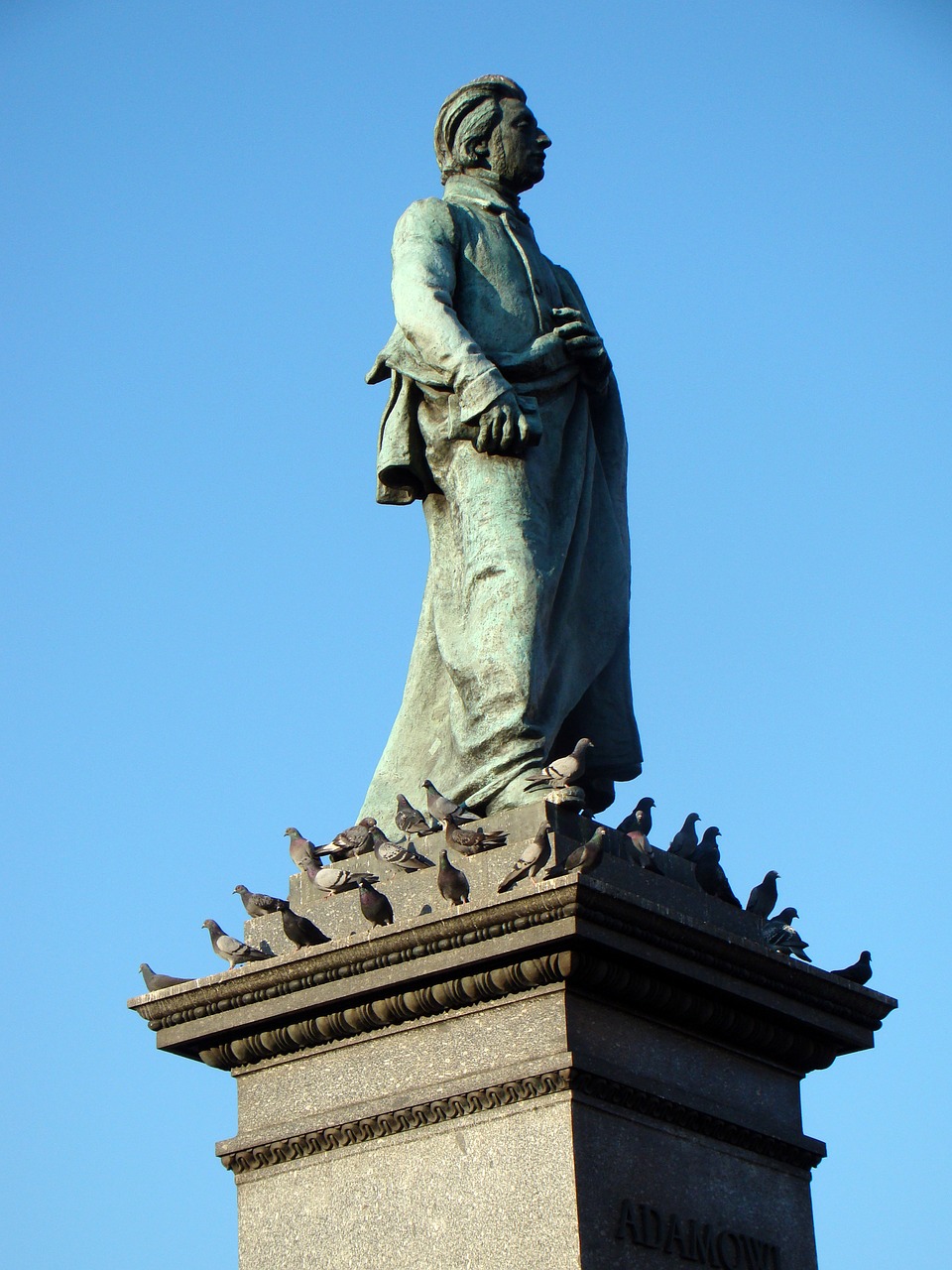 monument adam mickiewicz pigeons free photo