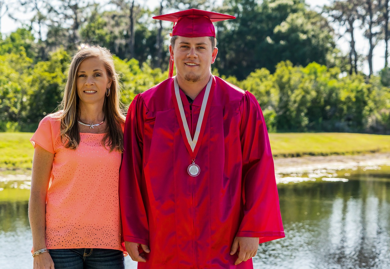 mother son  cap and gown  graduation free photo