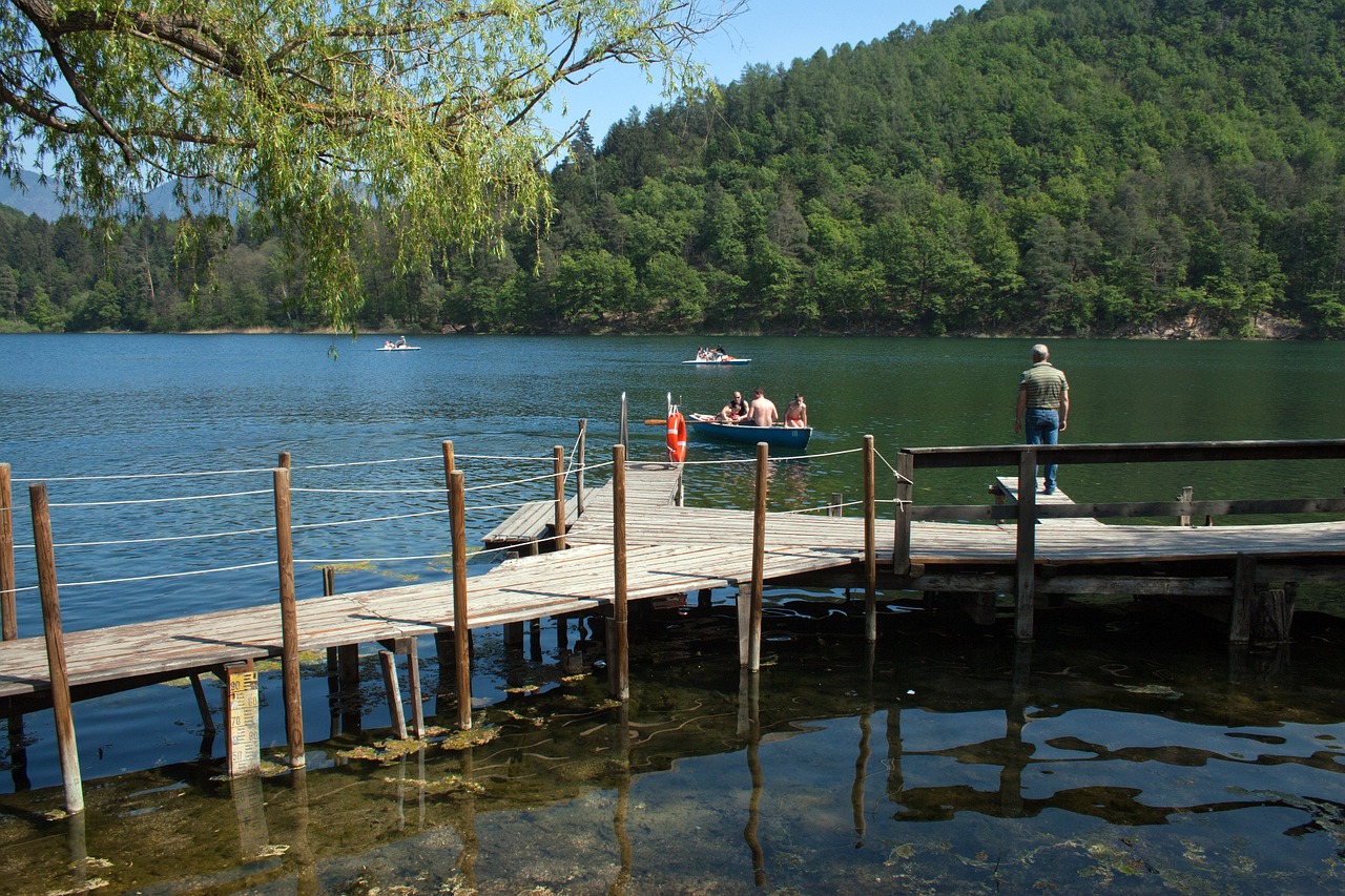 mountain lake timber jetty reflections free photo