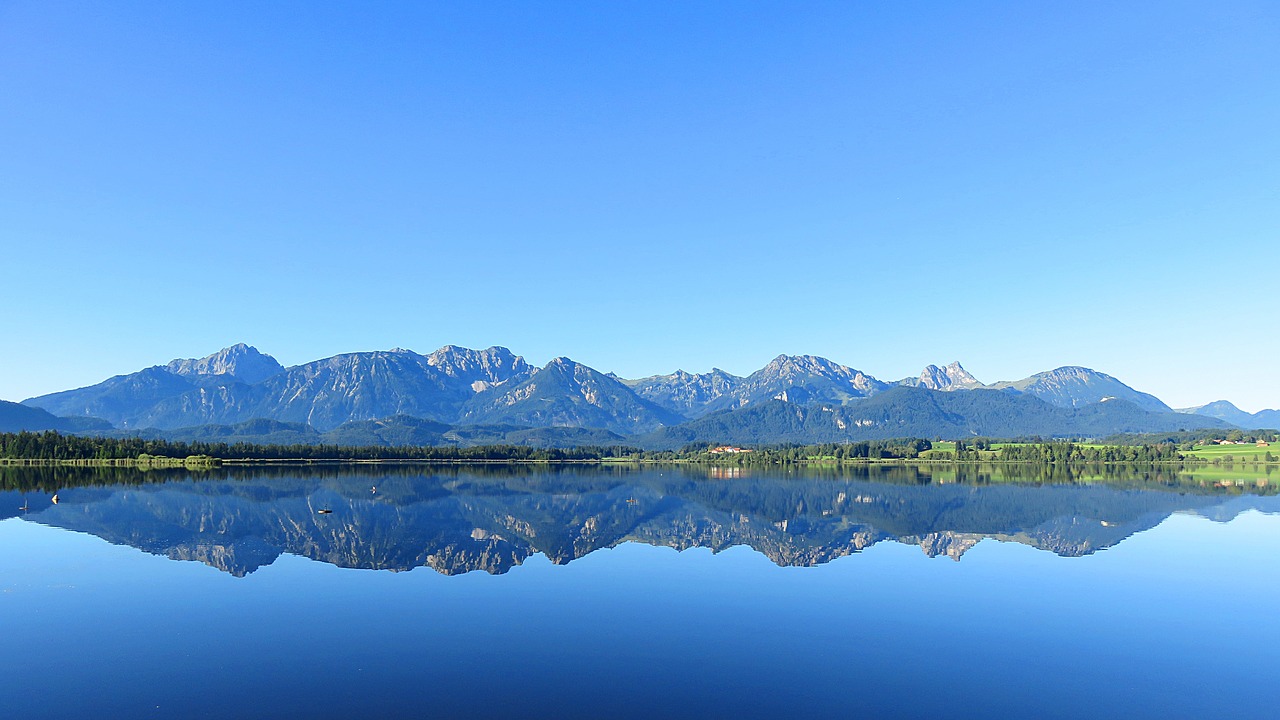 mountains mirroring water free photo