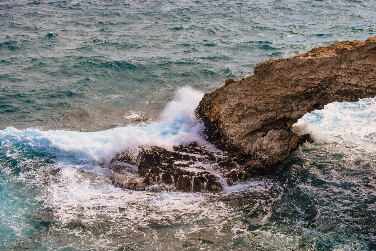 natural arch wave smashing free photo