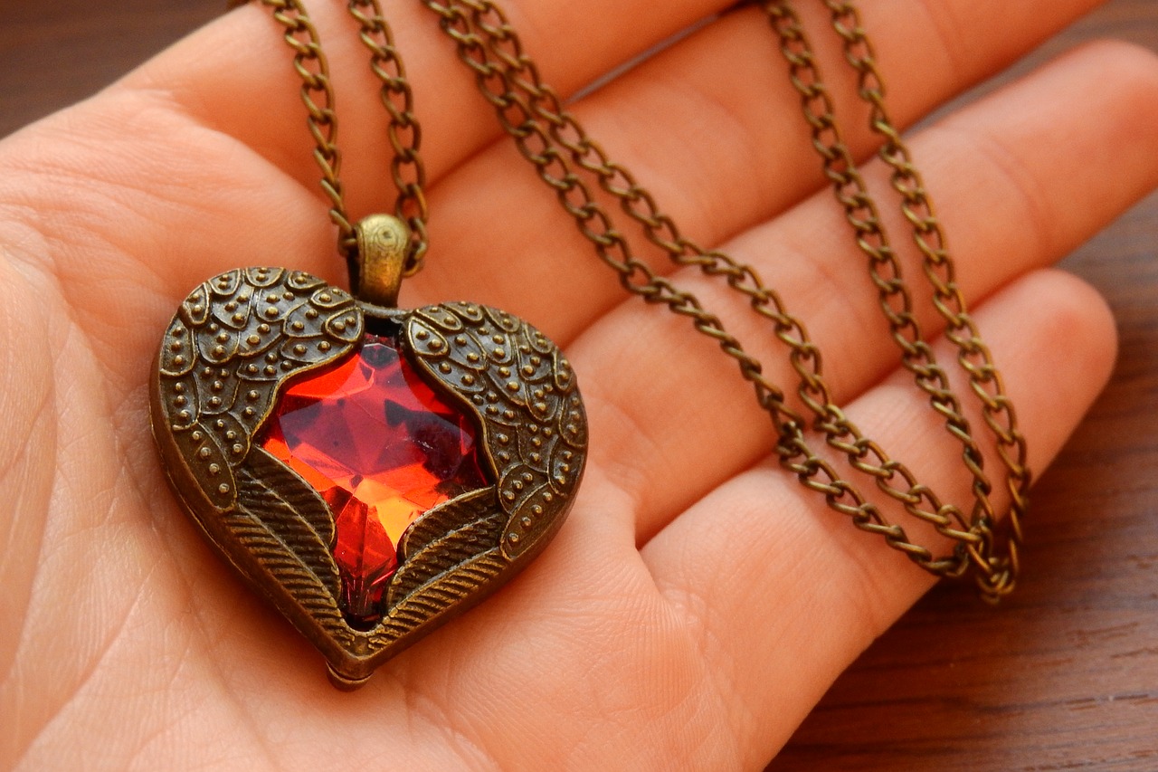 necklace with winged heart heart in hand winged heart free photo