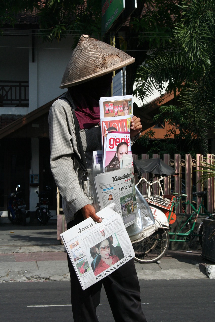 newspaper seller  indonesia  road free photo