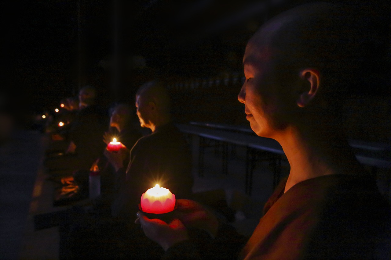 nuns with candles making wish making aspiration free photo