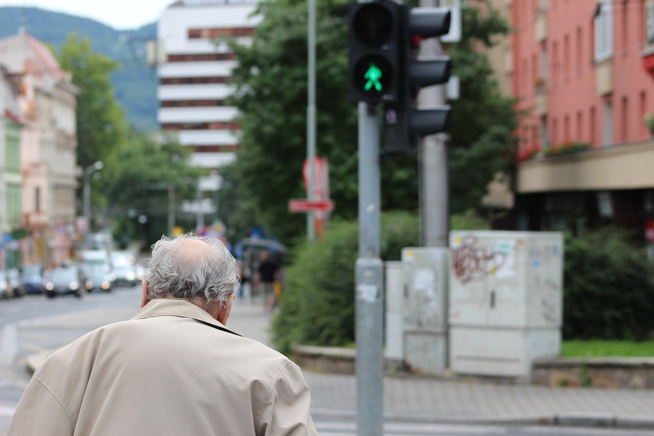 old man crossing street traffic lights old free photo