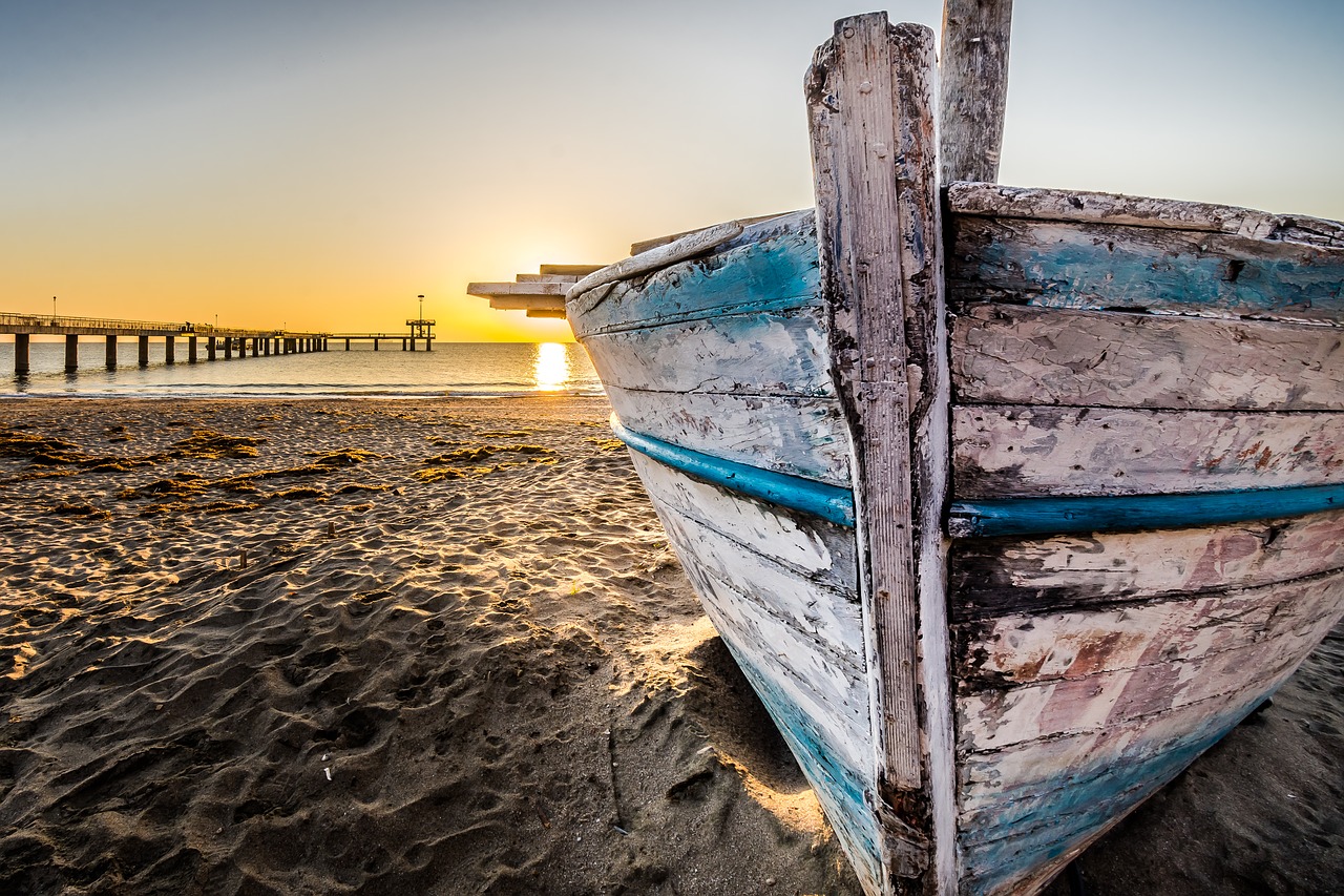 old wooden boat at sunrise wooden boat fishing boat free photo