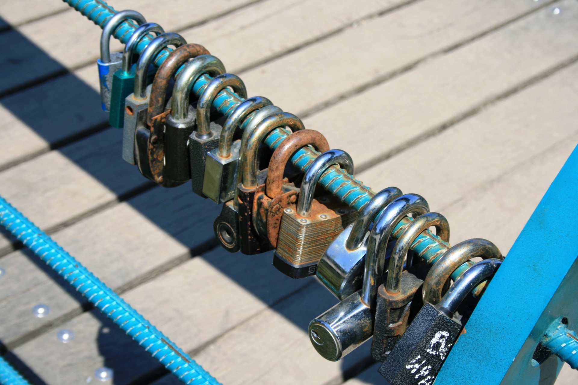 blue metal railing wooden bridge padlocks free photo
