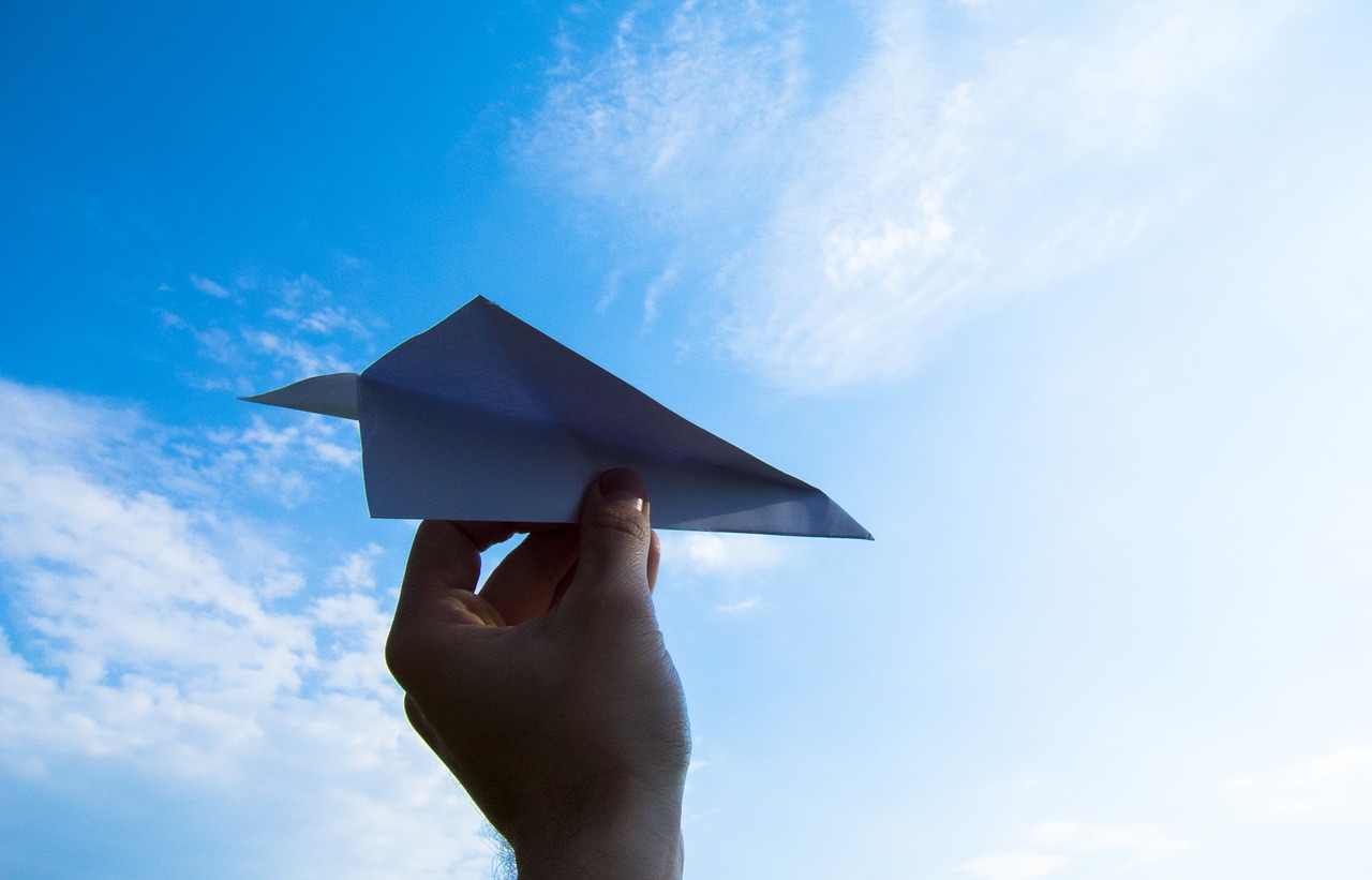 paper plane the hand sky free photo