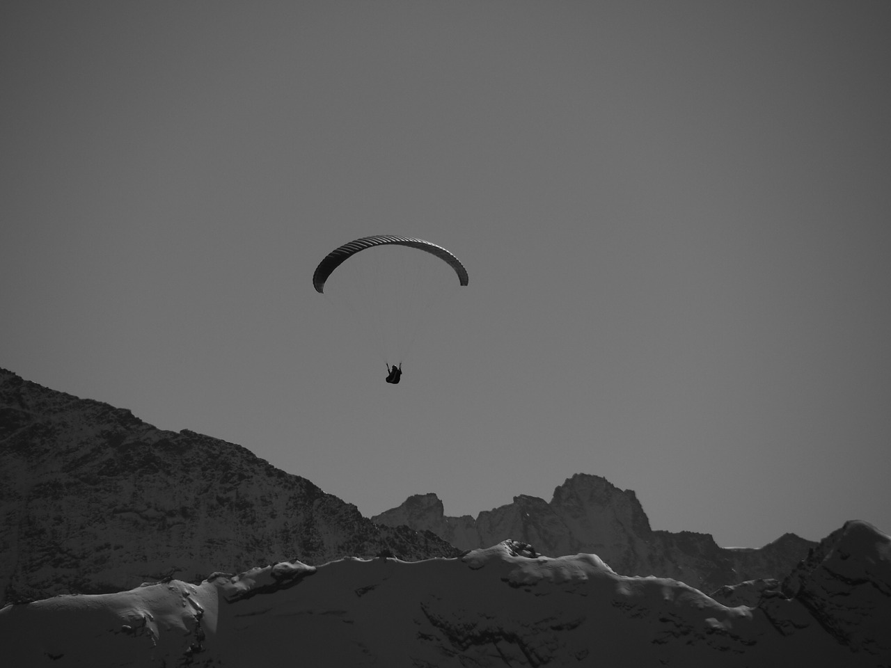 parachutist mountains black and white free photo