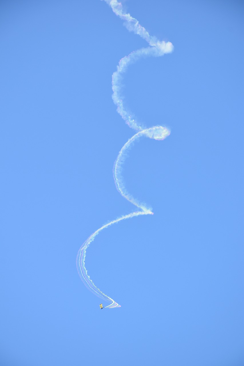 parachutist  smoke trail  sky free photo