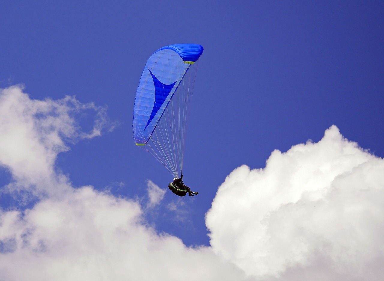 paraglider blue-in-blue sky