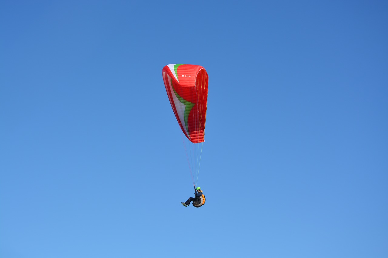 paragliding red sail blue sky free photo