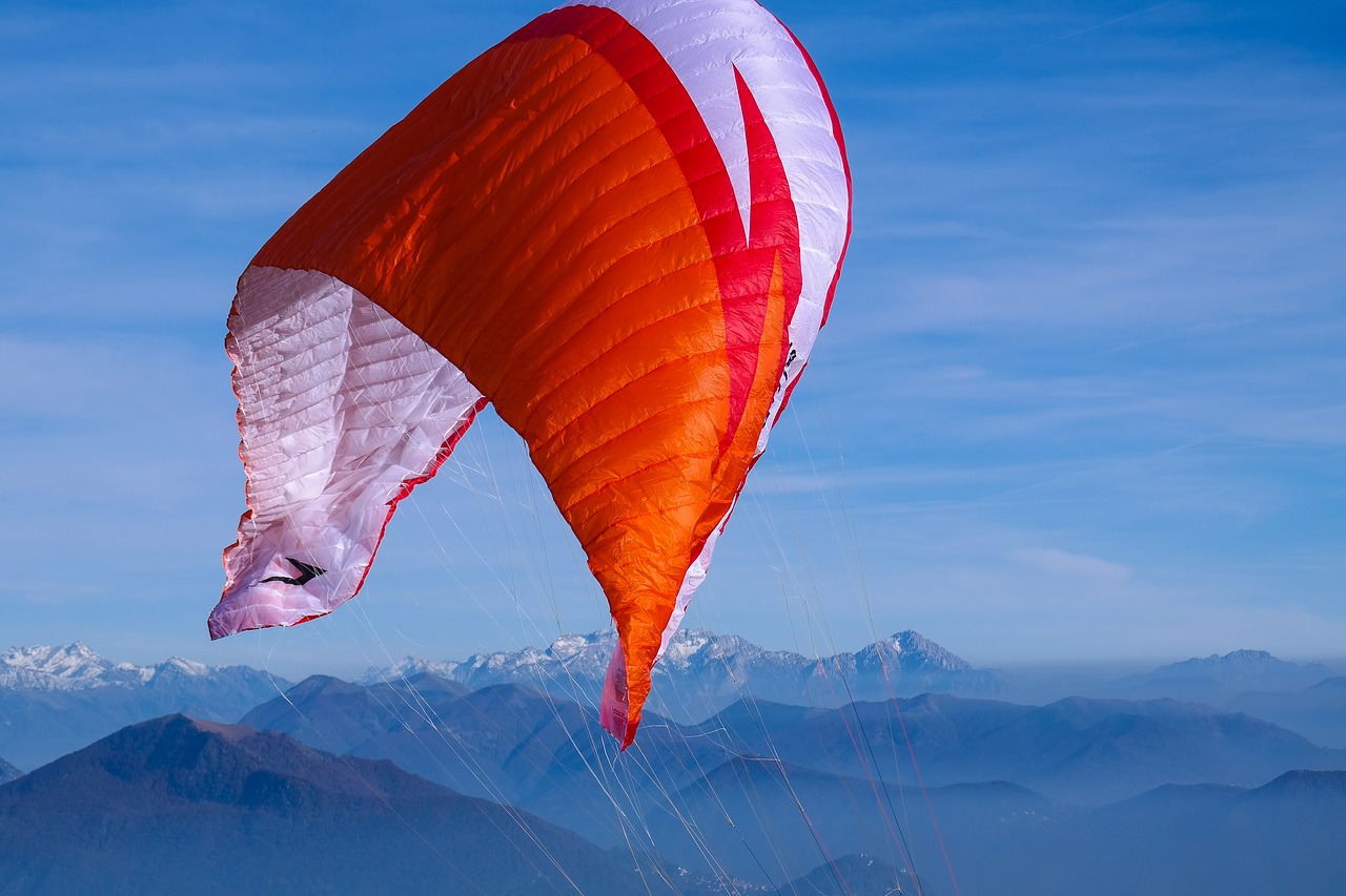 paragliding  mountains  sky free photo