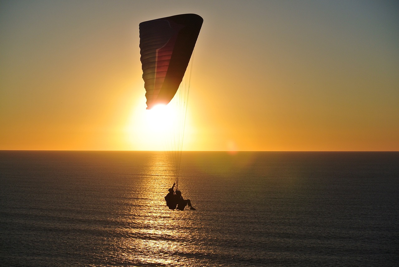 paragliding ocean sunset free photo