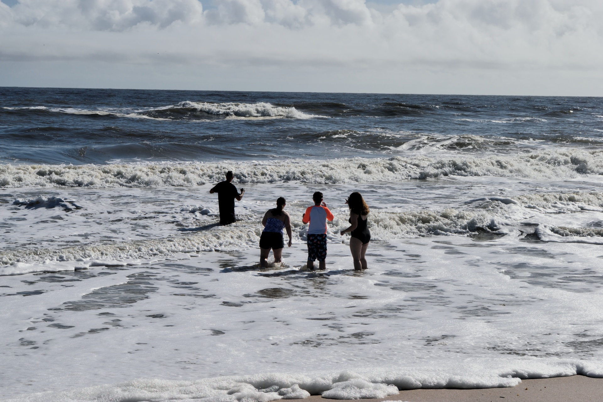 people wading ocean free photo