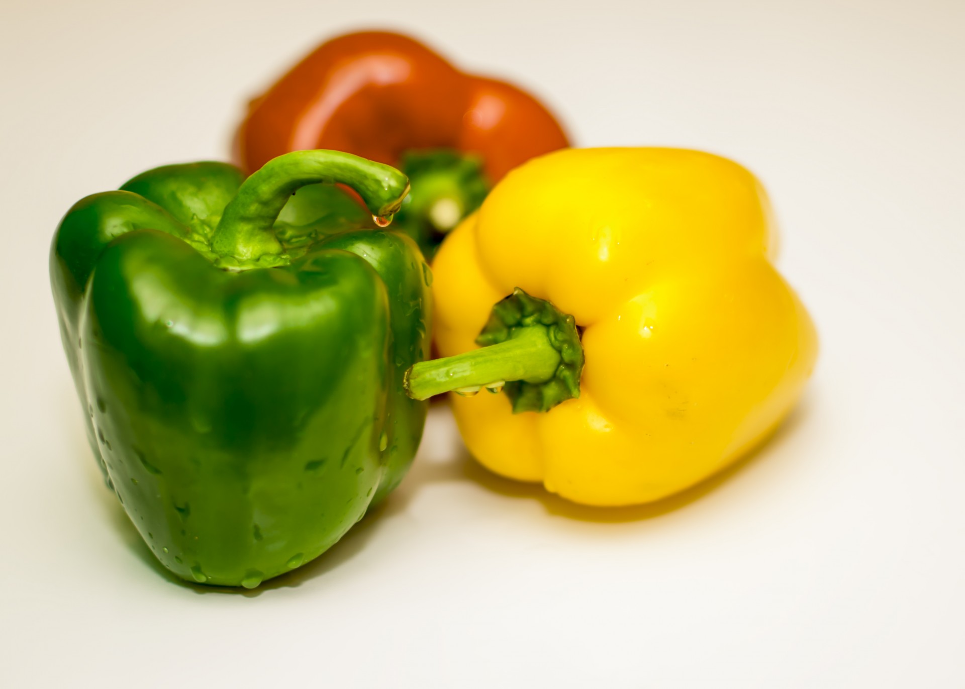 three color bell peppers yellow pepper green pepper free photo