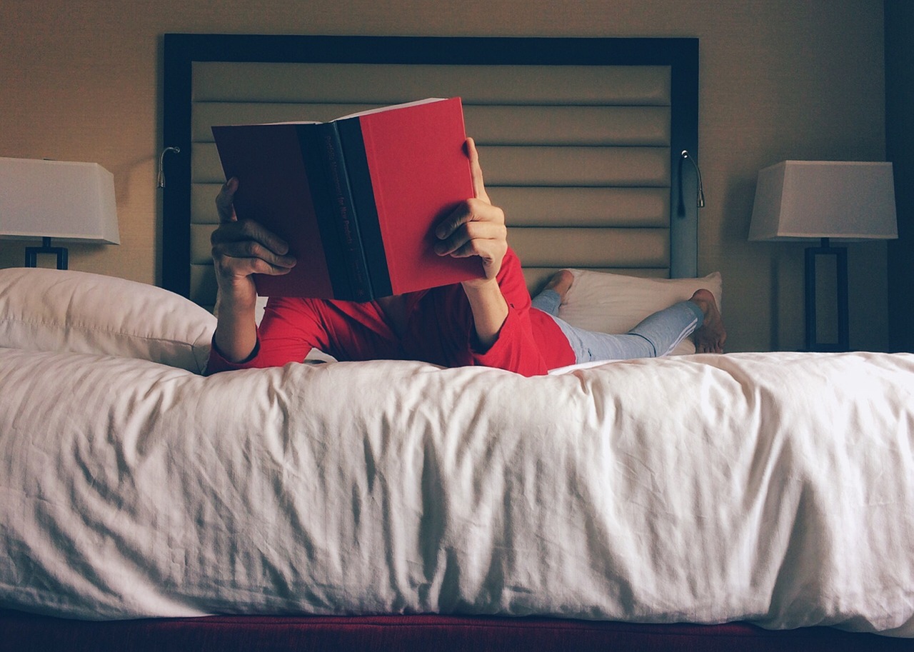 person reading bed free photo