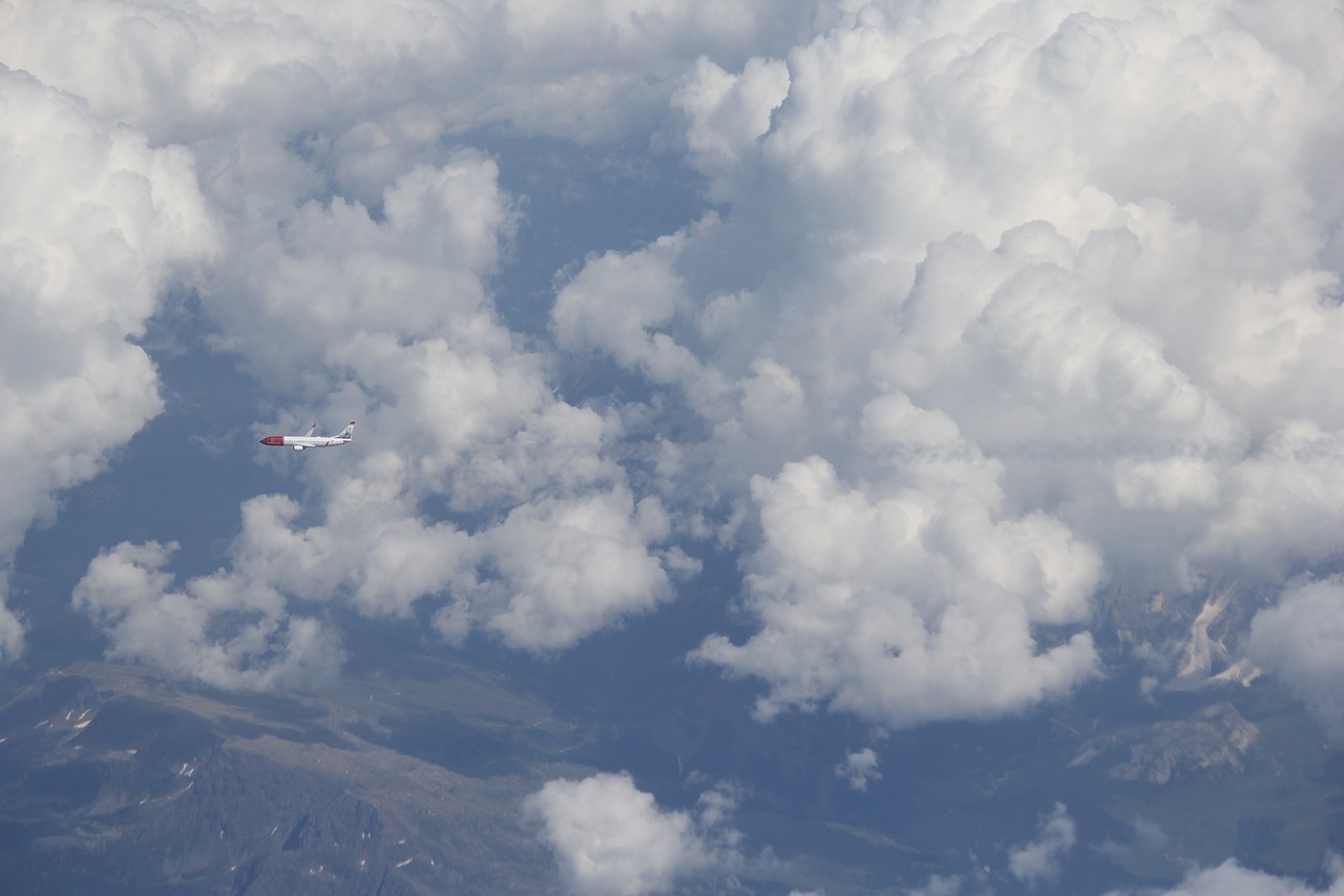 plane clouds mountains free photo