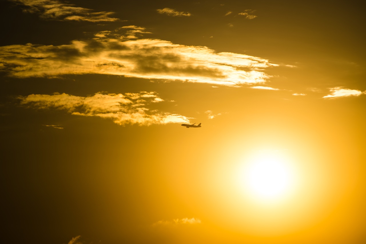 plane in a sunset sky sunset flight free photo