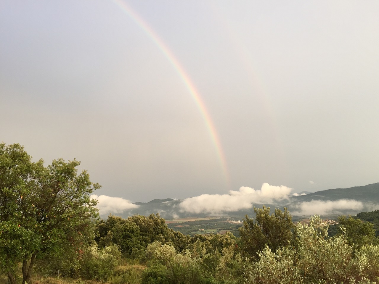 rainbow clouds mountain top free photo