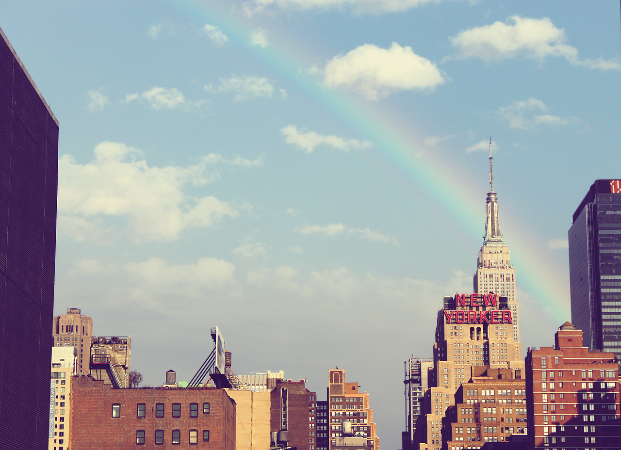 rainbow over city free photo