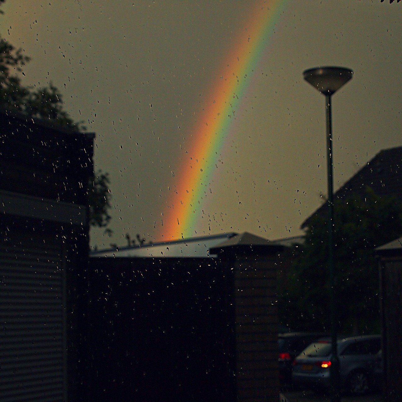 rainbow rain shower threatening sky free photo