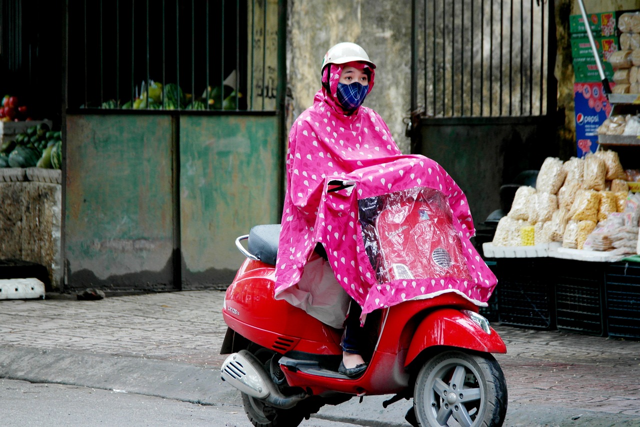 rainy moped rain coat free photo