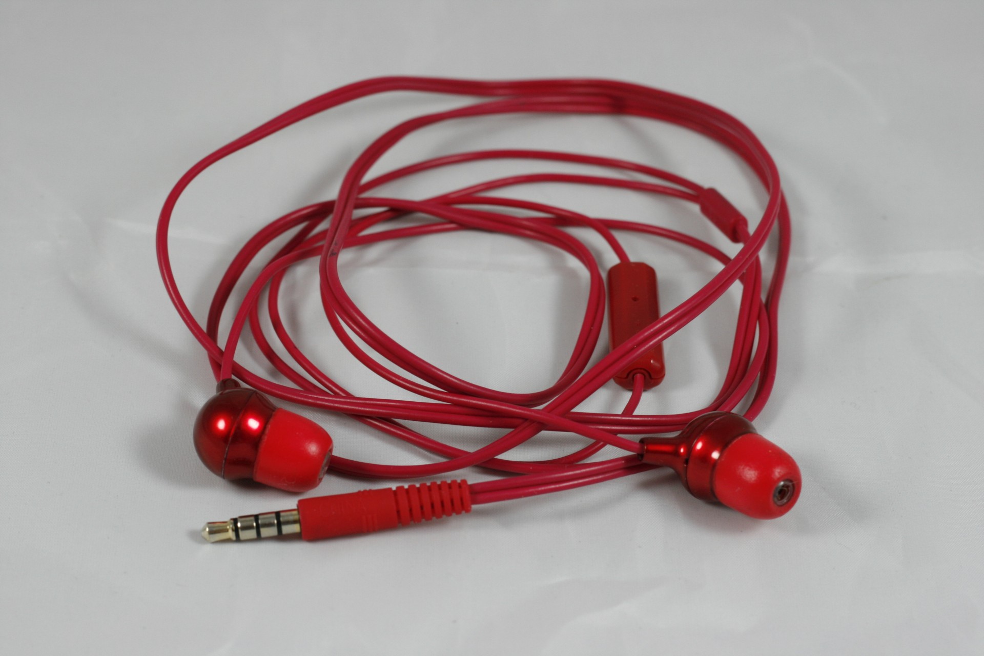 red earbuds red earbuds free photo