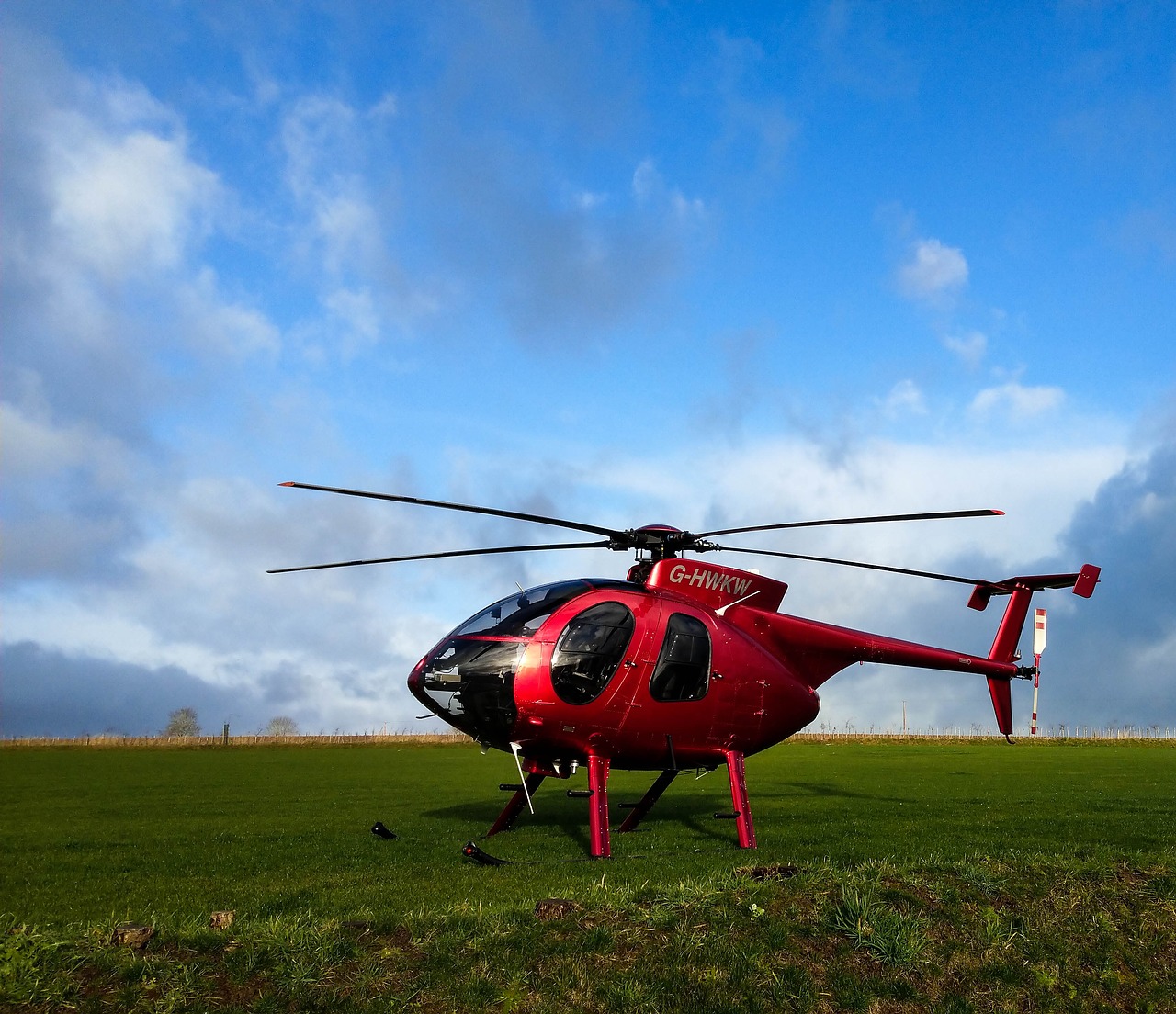 red helicopter  hughes md 500  helicopter on grass free photo