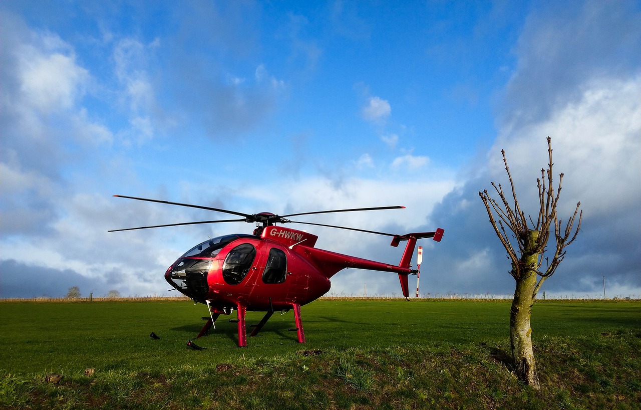 red helicopter  hughes md 500  helicopter on grass free photo