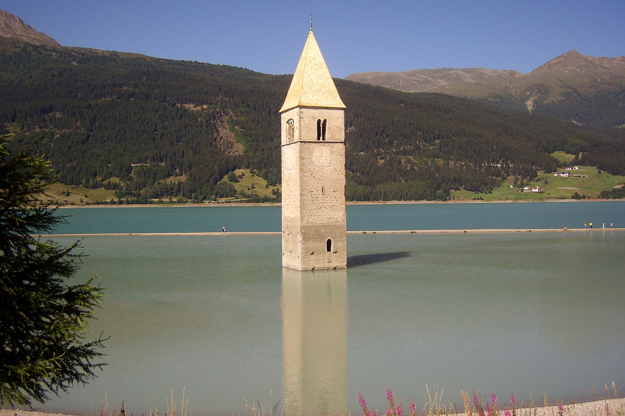 reschen pass tower in water landscape free photo