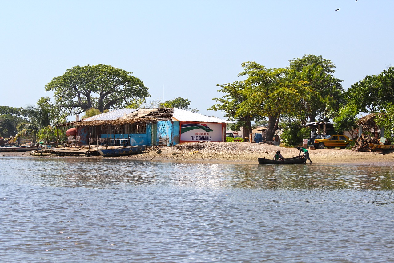 river scene gambia fishing village free photo
