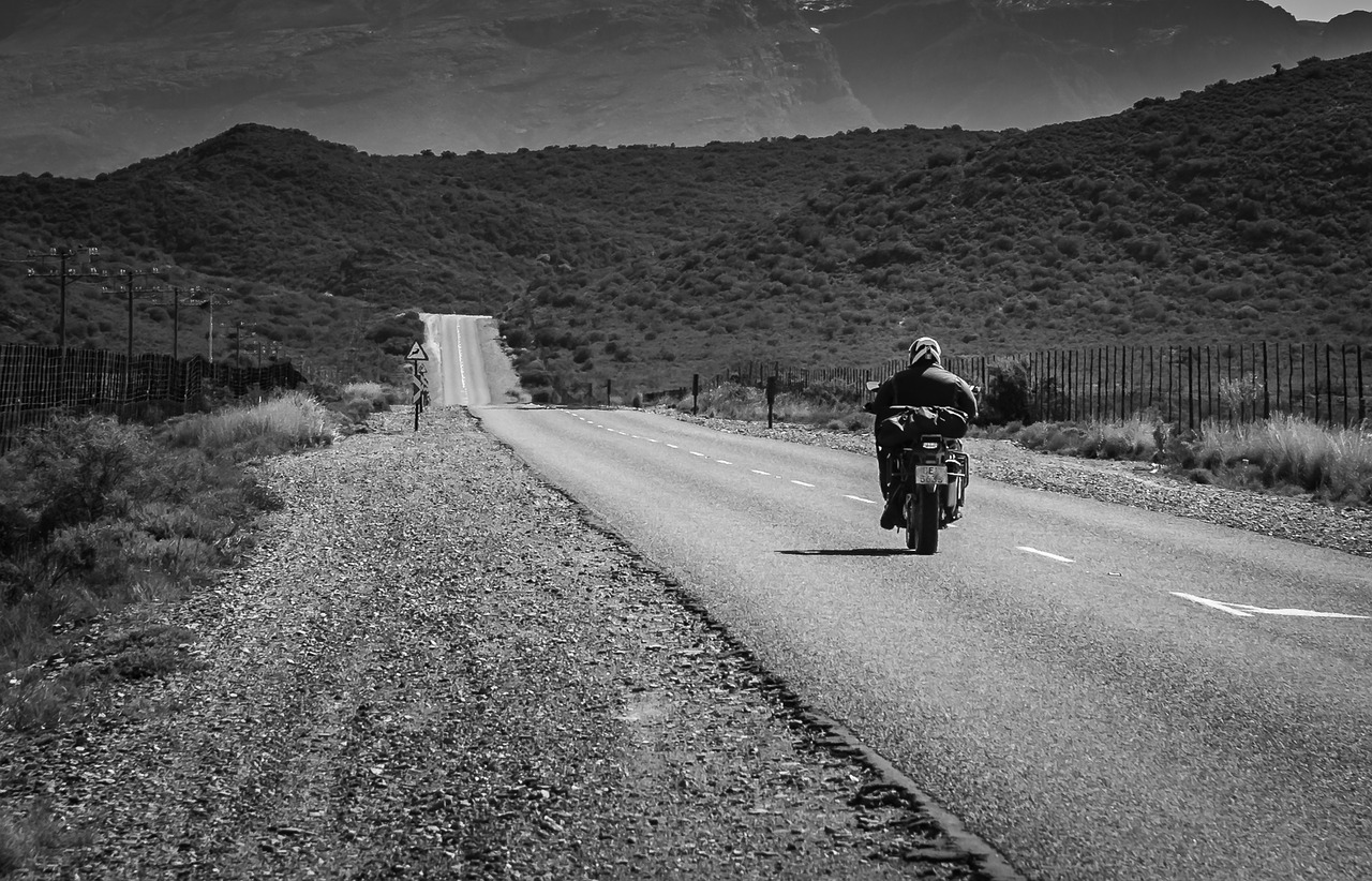 road  black white  motorcyclist free photo