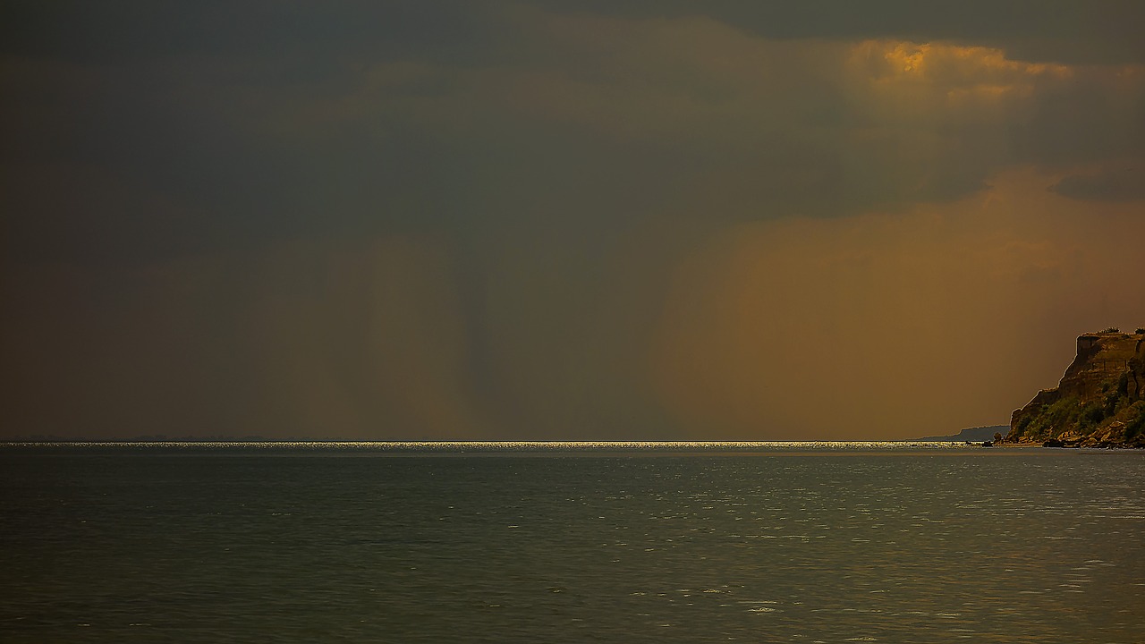 rock sea clouds free photo