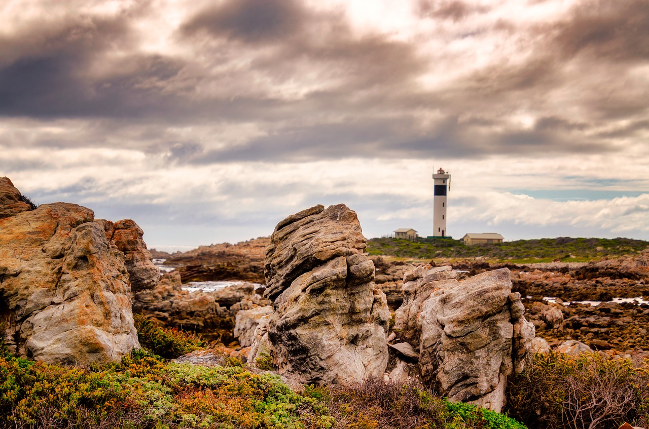 rocks  lighthouse  sky free photo