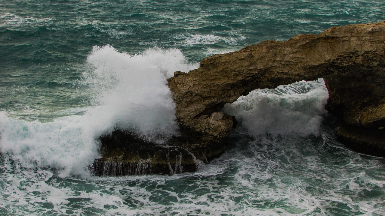 rocky coast natural arch wave free photo