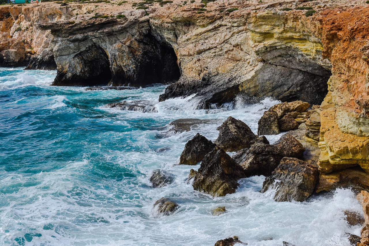 rocky coast sea caves waves free photo