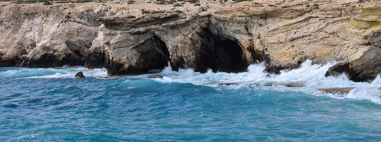 rocky coast sea caves waves free photo