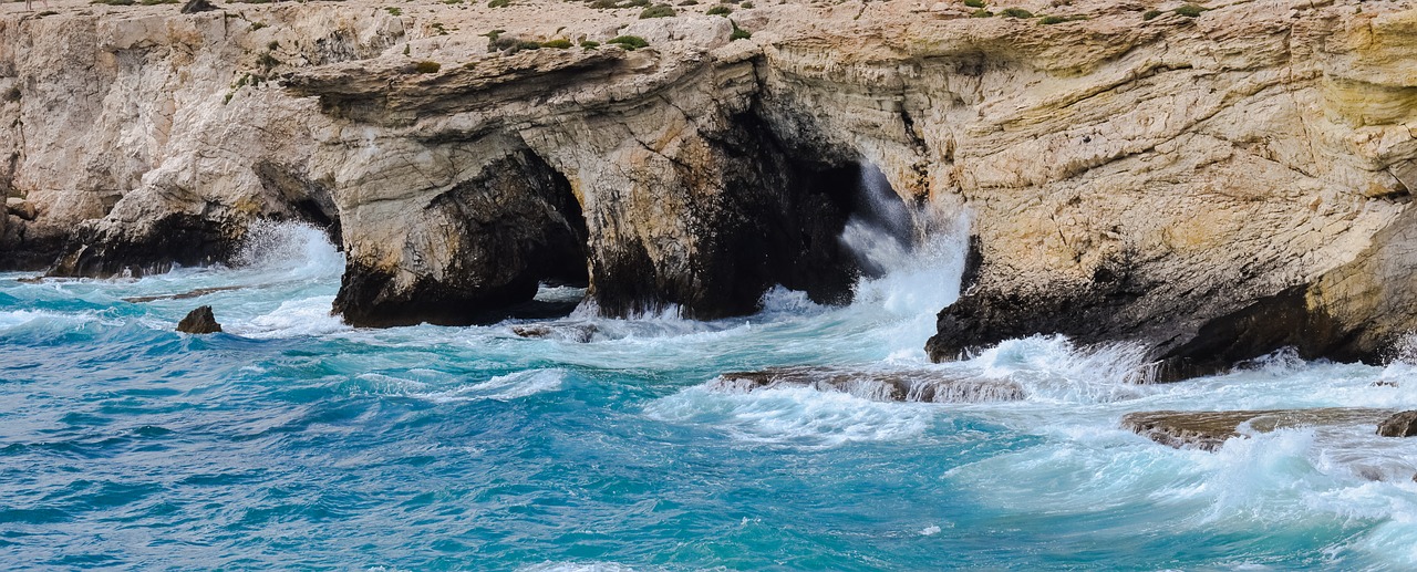 rocky coast sea caves waves free photo