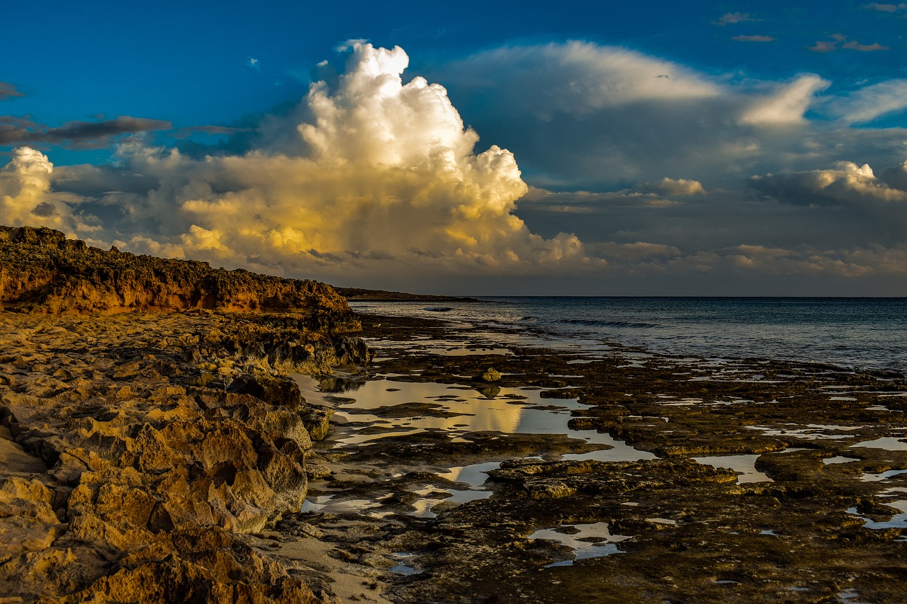 rocky coast  clouds  sky free photo