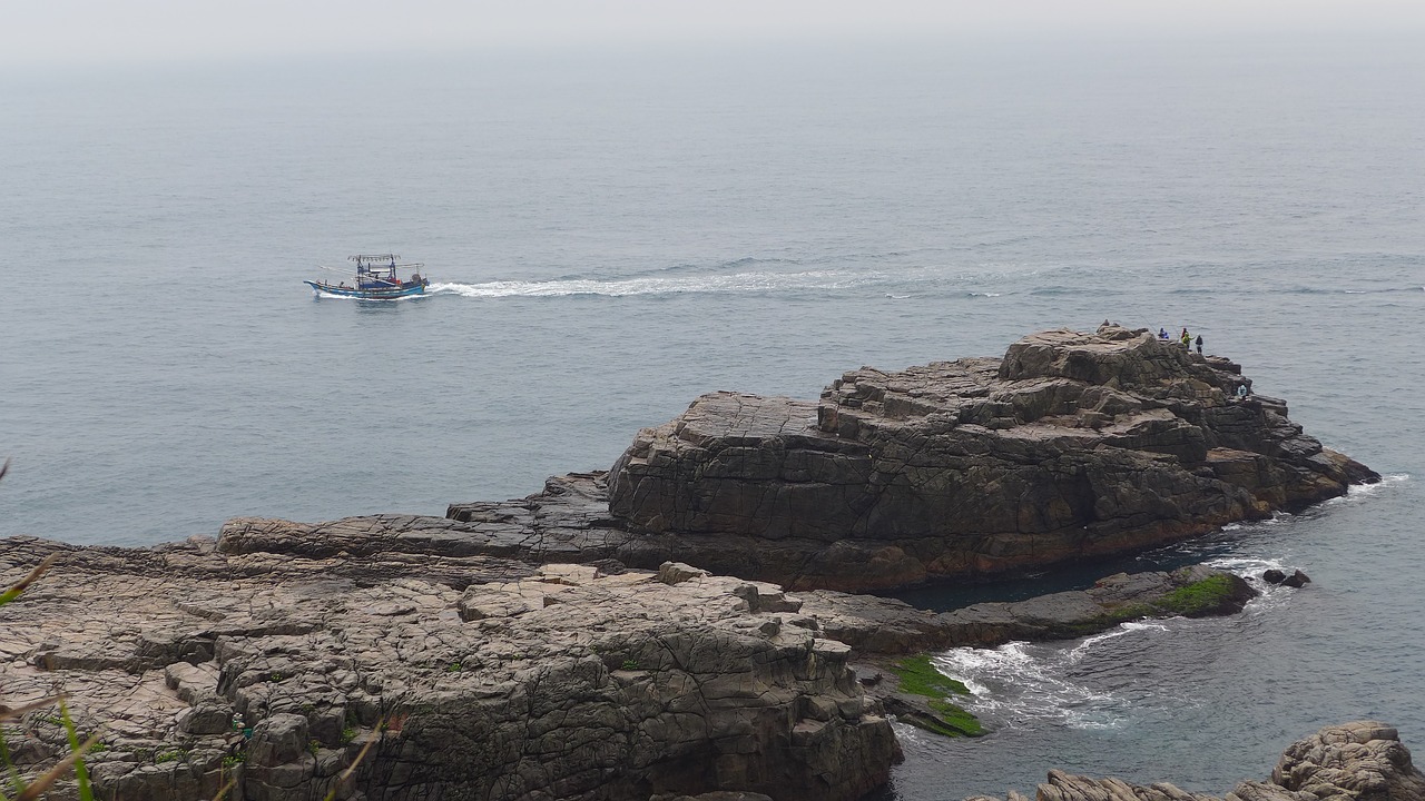 rocky shore boat landscape free photo